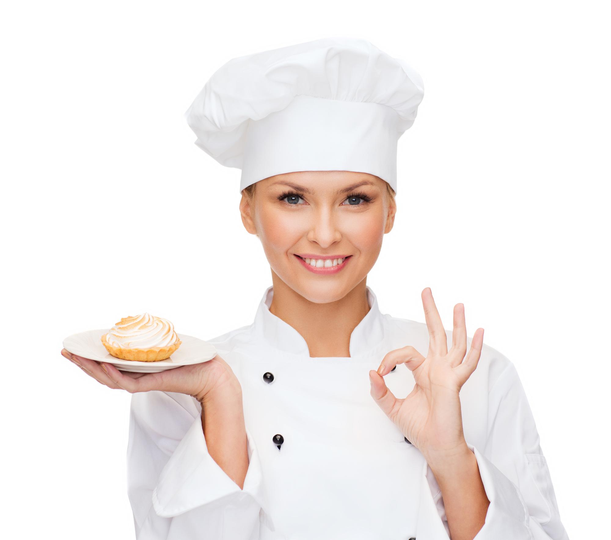 Chef holding a plate in a bright kitchen